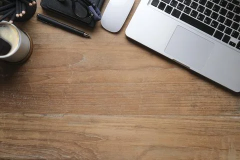 Top view simple workplace with laptop computer, coffee cup, glasses and noteb Foto stock