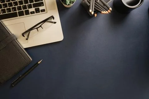 Top view simple workplace with laptop computer, coffee cup, and potted plan.. Stock Photos
