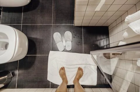 Top view. simplicity and solitude of morning routines, bare feet and bathroom Stock Photos