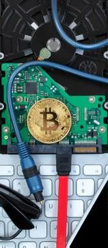 Top view of a single bitcoin on circuit board of computer drive with modern t Stock Photos