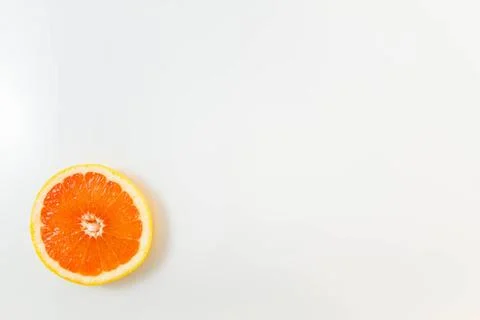 Top view of single grapefruit slice on white background Top view of single... Stock Photos