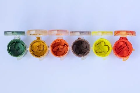 Top view of six opened plastic jars with gouache paint colors Stock Photos
