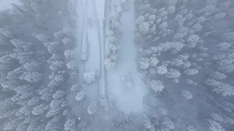 Top view of ski jumps and ski lift in foggy mountains Stock Footage 258110879