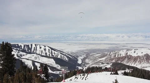 Top view on ski resort of Karakol, paraglider in the sky Video stock 59573609