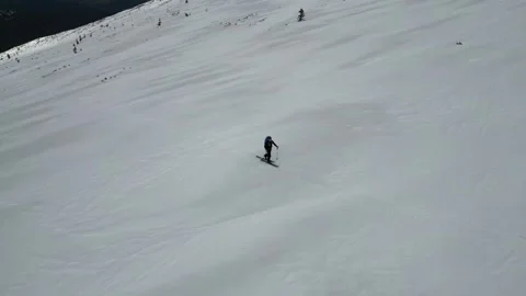 A top view of a ski tourist with backpack crossing a snowy field. Winter ex.. Stock Footage 240651122