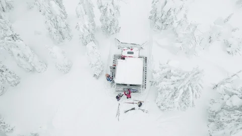 Top view of skiers taking their gear out of truck in snowy forest, Red Mountain Stock Footage 121585793