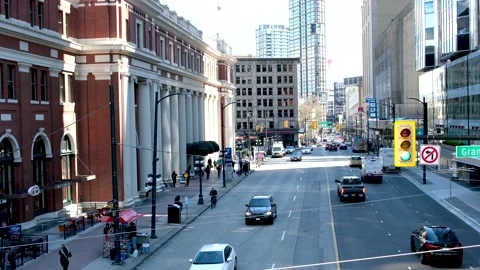 Top view of Sky Train waterfront station in Vancouver Granville st Cars pass Stock Footage 238546822