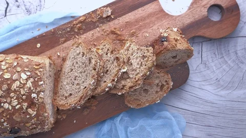 Top view of slice of brown bread on chopping board 스톡 동영상 125722894