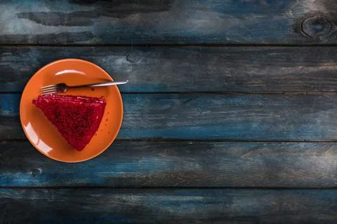 Top View. Slice of delicious Red velvet cake on a ceramic plate with a fork on a Stock Photos