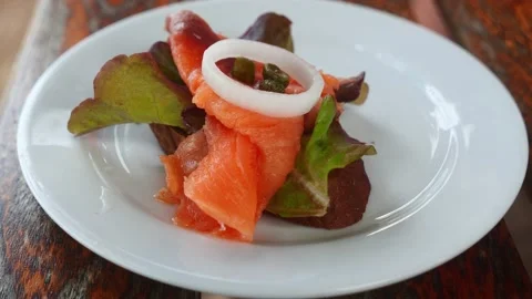 Top view. Slice of a whole grain bread with salted salmon fillet and greens 스톡 동영상 202156778
