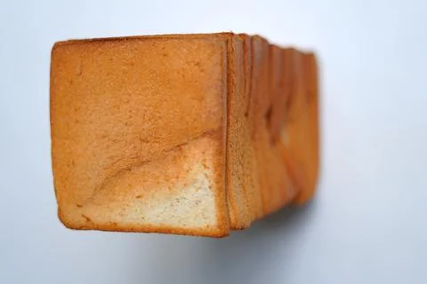 Top view of sliced bread on a white board Stock Photos