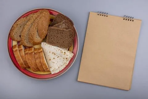 Top view of sliced breads as seeded brown cob flatbread crusty and rye ones.. Stock Photos