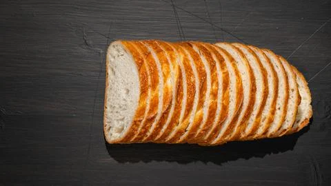 Top view of slices of white bread on wooden chopping board Stock Photos