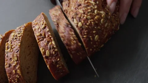 Top view of Slicing Freshly Baked Multigrain Bread Stock Footage 285566703