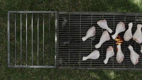 Top view slider shot of large chicken legs being grilled Stock Footage 145830967