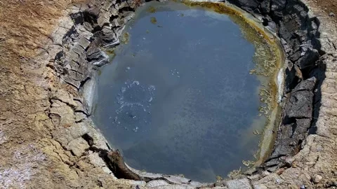 Top view of a slightly bubbling mud volcano Stock-Footage 316880640