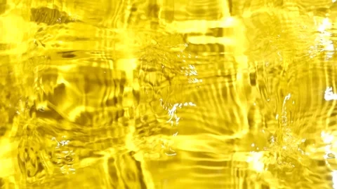 Top view slow motion of abstract golden yellow water ripples with light caustics Stock Footage 344797644