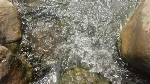 Top view Slow motion cascade of a clear flowing rocky river Stock Footage 323043316