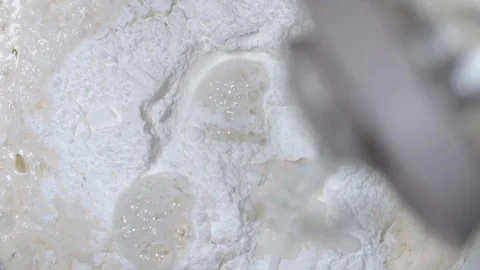 Top view slow motion close up shot water pouring into bowl full of flour. Stock Footage 116688535