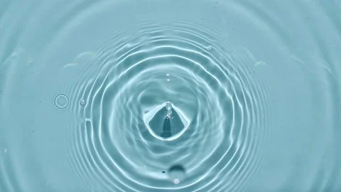 Top view slow motion of drop falls into water and diverging circles of water on Video stock 163207451