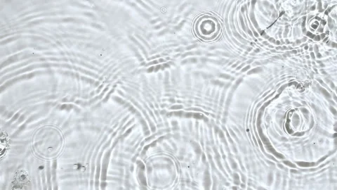 Top view slow motion of drop falls into water and diverging circles of water Stock Footage 253774291