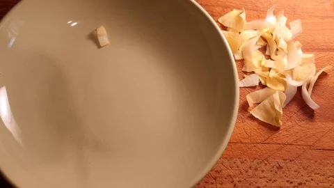 Top view slow motion of endive salad  cut in small bites falling on plate. Stock Footage 117137245