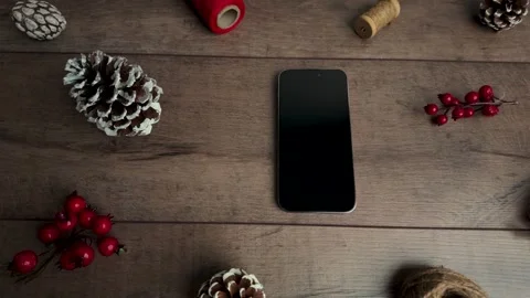 Top view slow motion shot sliding right with smartphone centered in holiday.. Video stock 321545495