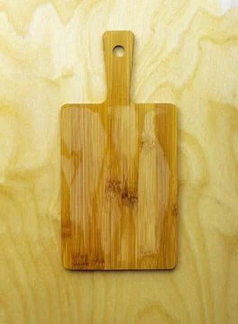 Top view of a small bamboo board that lies on a wooden table Stock Photos