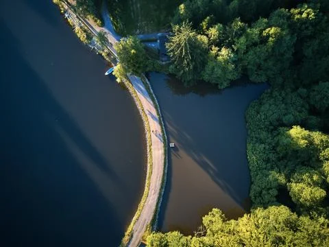 Top View of a small lake and green trees around with a small path or street Stock Photos