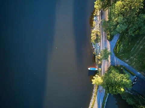 Top View of a small lake and green trees around with a small path or street Stock Photos