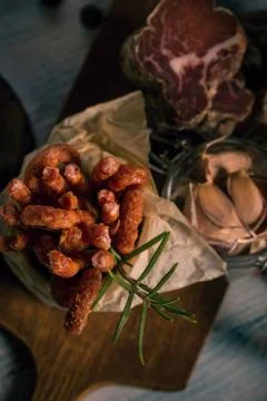 Top view on small thin spiced sausages next to meat pieces and garlic Stock Photos