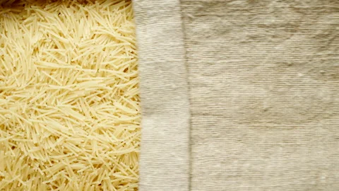 TOP VIEW: Small vermicelli pasta under opening sackcloth Stock Footage 171148791