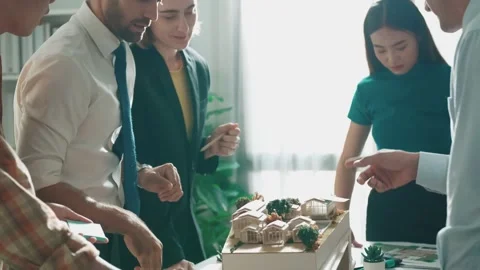 Top view of smart manager point at house model and explain design. Alimentation. Stock Footage 269306814