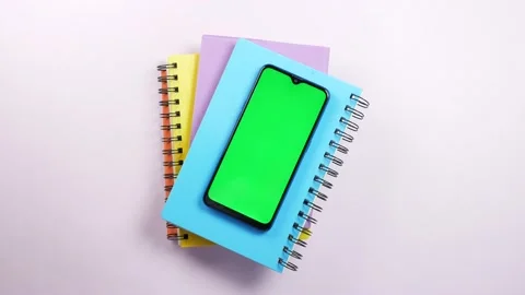 Top view of smart phone and notepad on table Stock Footage 211839999