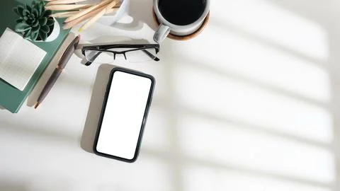 Top view smart phone with empty screen, notebook and coffee cup on wooden o.. Stock Photos