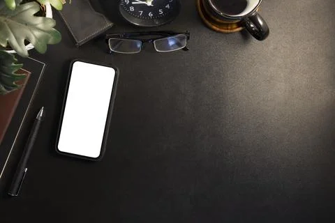 Top view smart phone with empty screen, glasses, coffee cup and books on bl.. Stock Photos