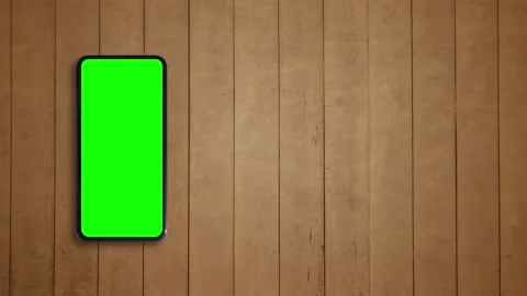 Top view, Smart phone place on table wood with green screen, Close-up the cell p Vídeos de archivo 132593768
