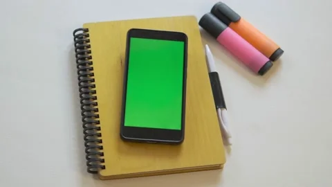 Top view, Smart phone place on table wite with green screen, Close-up the cell Stock Footage 166390365