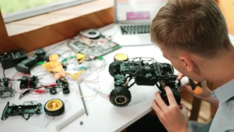 Top view of smart student study car model construction at table. Edification Stock Footage 280273035