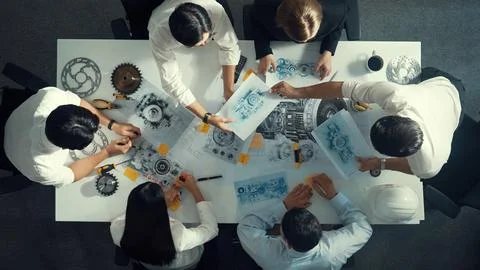 Top view of smart team working together to design turbine engine. Alimentation. Stock Photos