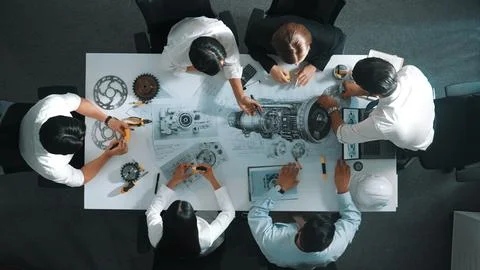 Top view of smart team working together to design turbine engine. Alimentation. Stock Photos