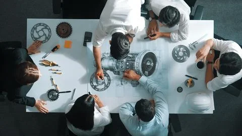 Top view of smart team working together to design turbine engine. Alimentation. Stock Photos