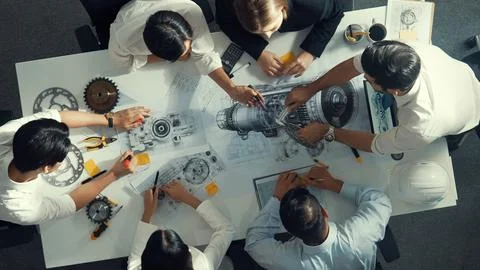 Top view of smart team working together to design turbine engine. Alimentation. Stock Photos