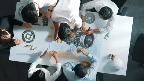 Top view of smart team working together to design turbine engine. Alimentation. Stock Photos