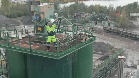 Top view of smiling afro-american engineer standing on top of concrete batching Stock Footage 124306336