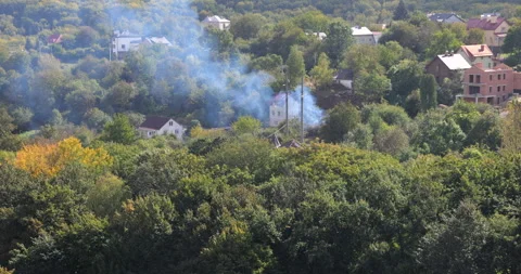 Top view of smoke from burning dry grass and tops from the crop Stock-Footage 252321704