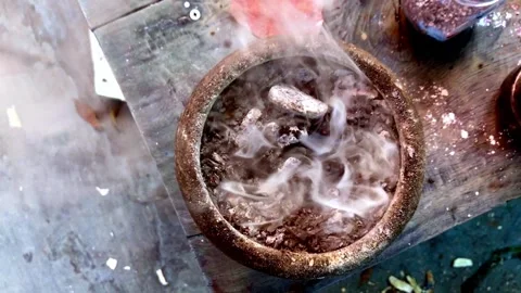 Top View of Smoking Clay Pot With Burning Ingredients on Rustic Wooden Table Stock Footage 335991811
