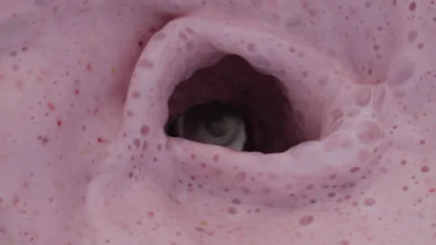 Top view smoothie surface swirling in blender close up. Fruit milkshake mixing. Stock Footage 219013419