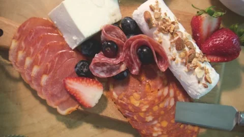 Top view of a snack party spread featuring a charcuterie board Stock Footage 318555498