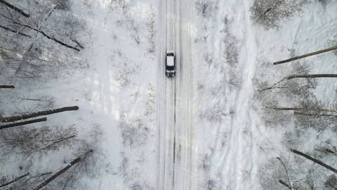 Top view of the snow-covered forest, the road in the forest Stock Footage 120197428
